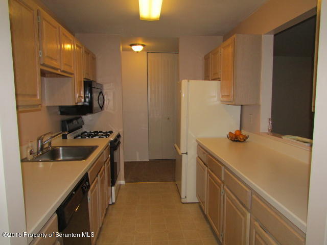 1412 Summit Pointe Scranton, PA 18508 - Photo 2 of 31 a kitchen with a sink a stove and a refrigerator