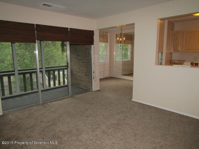 1412 Summit Pointe Scranton, PA 18508 - Photo 8 of 31 an empty room with sliding glass door and mountain view