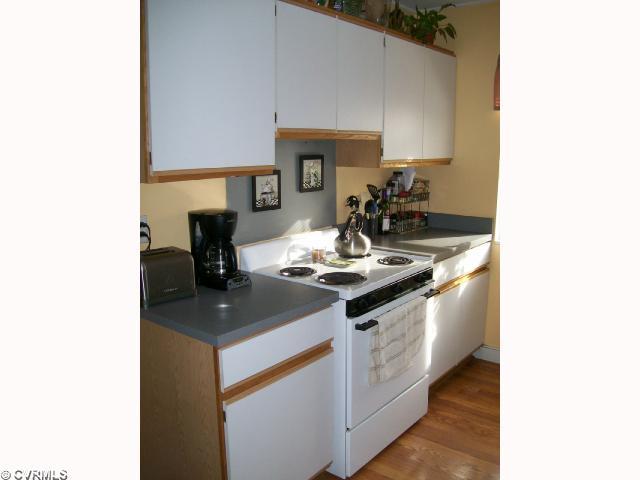 Kitchen - Freshly painted, laminate wood floors and lots of cabinets