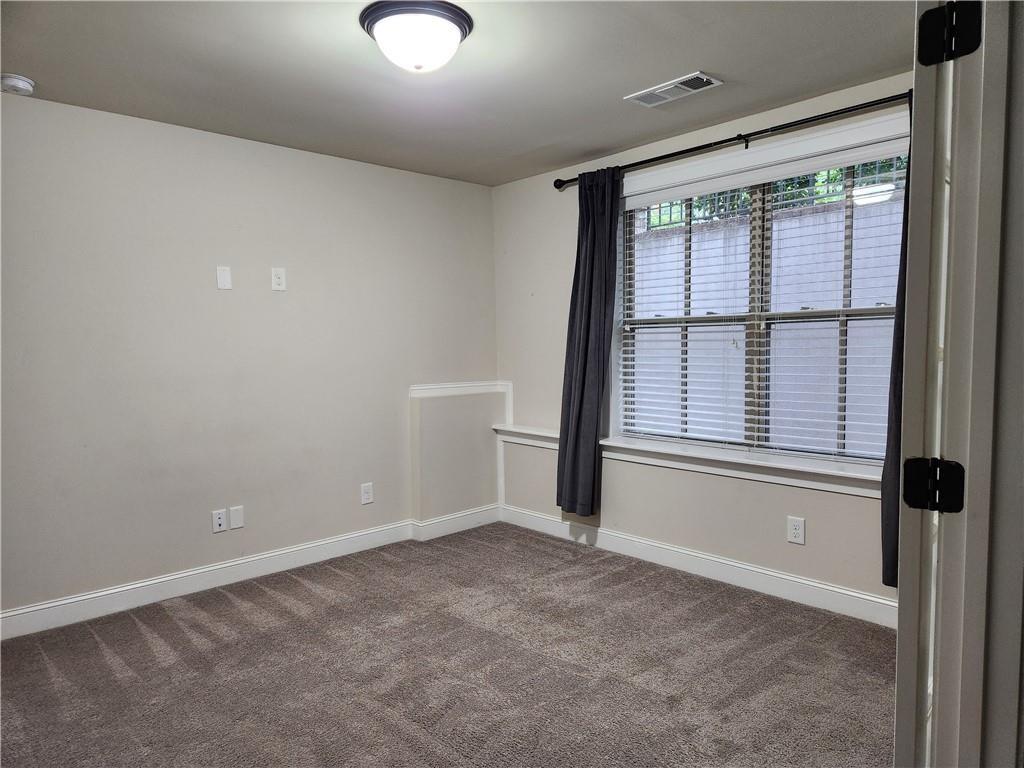 1323 Faircrest Way Suwanee, GA 30024 - Photo 16 of 16 an empty room with windows