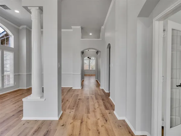 a view of hallway with wooden floor and stairs