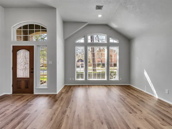 wooden floor in an empty room with a window