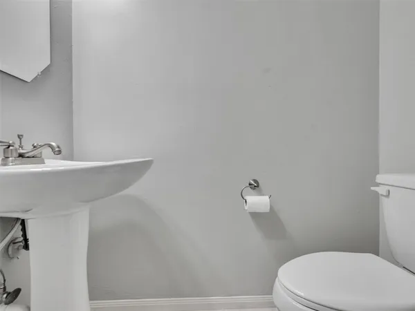 a bathroom with a sink a toilet and mirror