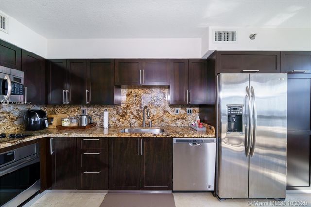 a living room with furniture and floor to ceiling window
