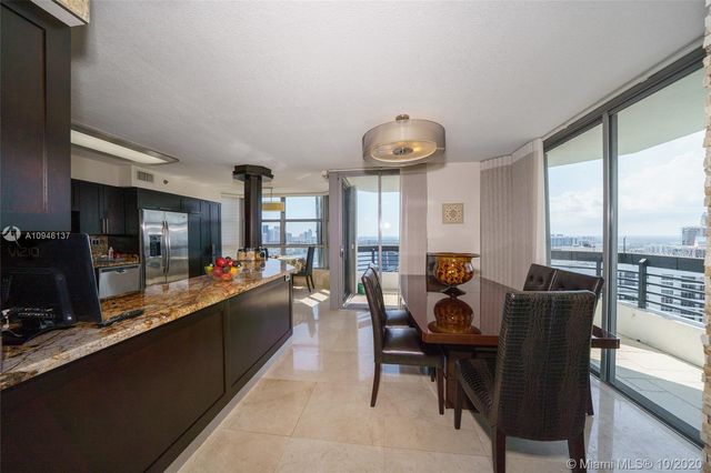 a spacious bedroom with a bed and a flat tv screen