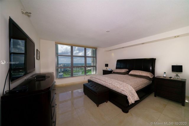 a bedroom with a bed and a tv