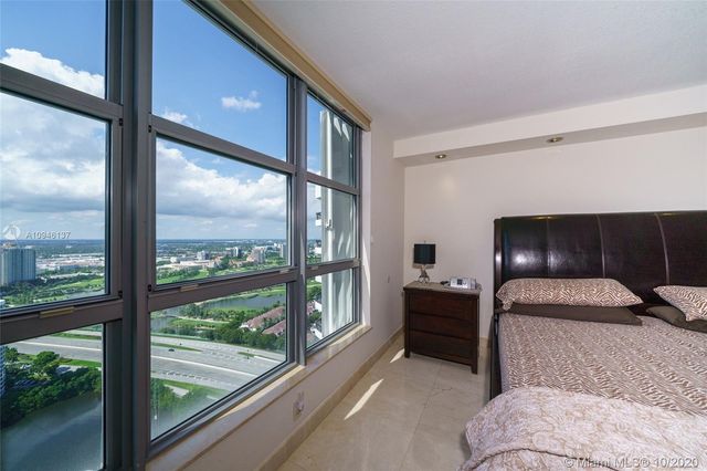 a spacious bathroom with a bathtub sink and mirror