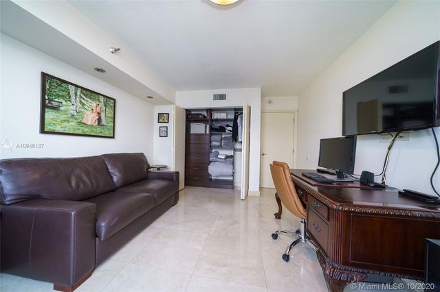 a bathroom with a granite countertop sink a toilet a mirror and shower