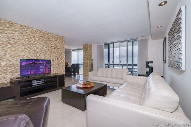 a kitchen with kitchen island granite countertop a sink a counter top space and cabinets