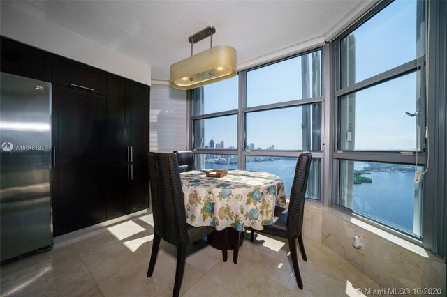 a large kitchen with kitchen island granite countertop a sink dishwasher stove and cabinets