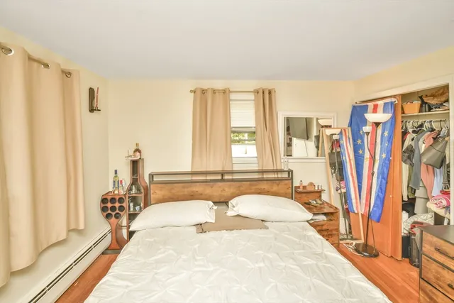 a spacious bedroom with a bed and a large window