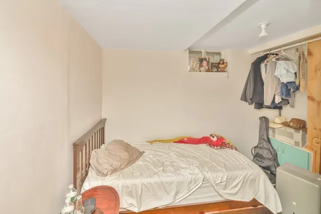 a bedroom with a bed and a painting on the wall