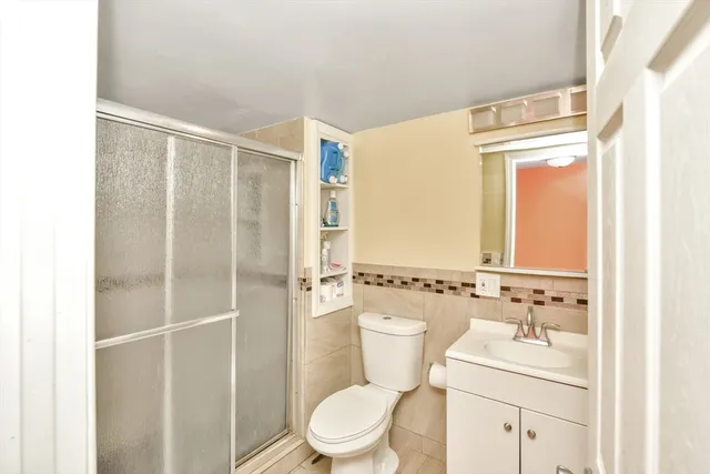 a bathroom with a toilet a sink and a shower