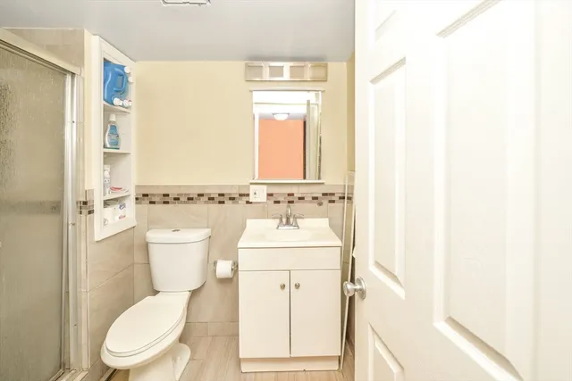 a bathroom with a toilet a sink and a mirror