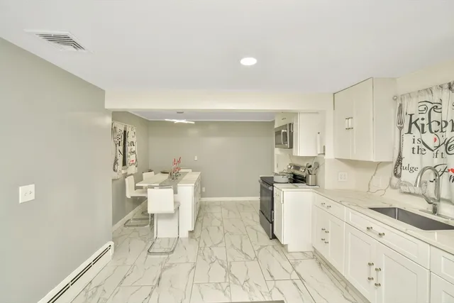 a kitchen with a sink and breakfast area