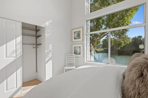 a bedroom with a bed and a painting on the wall