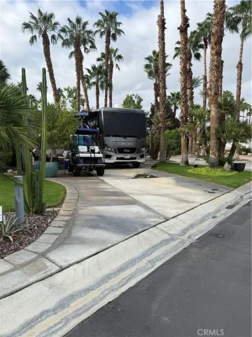 a view of a street with a car parked on the roadside
