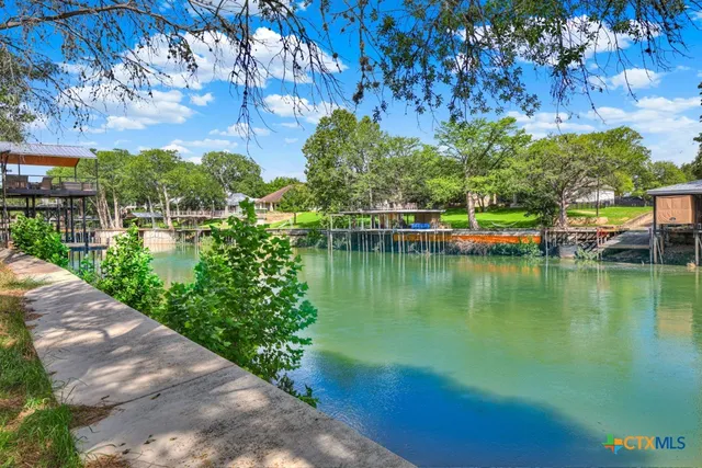 a view of a lake with a house in the background