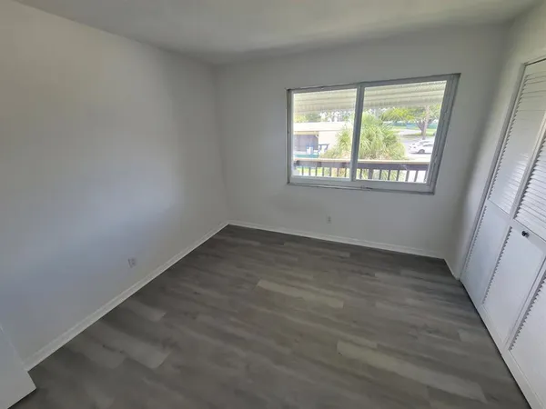 a view of room with guitars and wooden floor