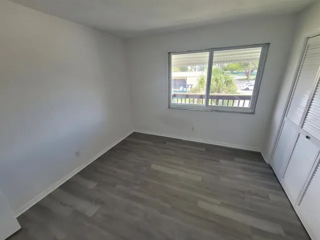a view of room with guitars and wooden floor
