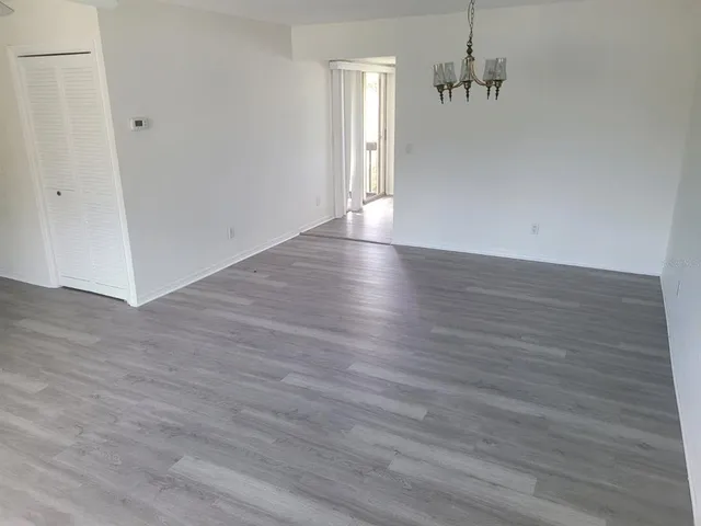 a view of a room with wooden floor