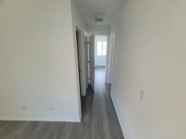 a view of a hallway with wooden floor