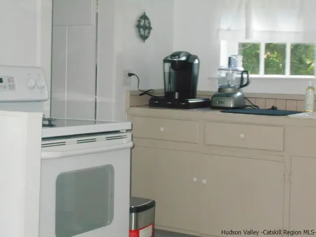 a bedroom with a bed and a mirror