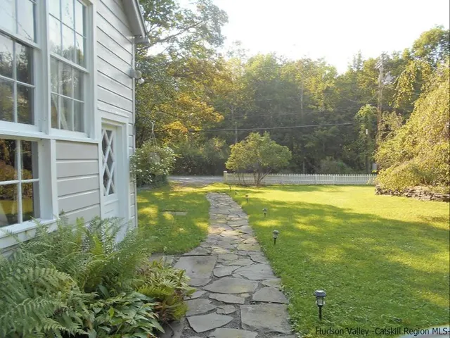 a living room with furniture and a lamp
