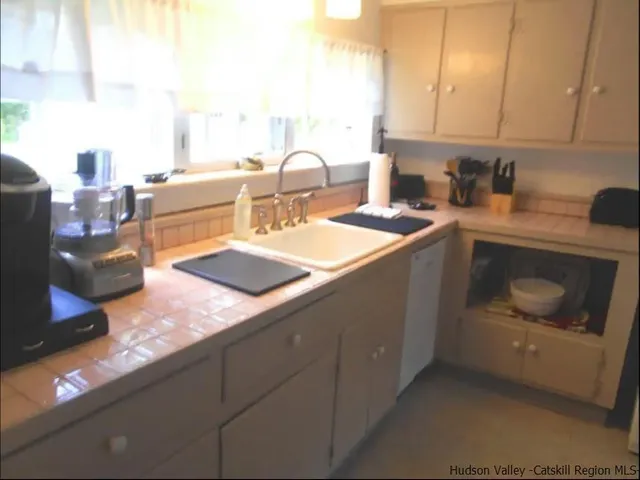 a kitchen with a stove and a white cabinet