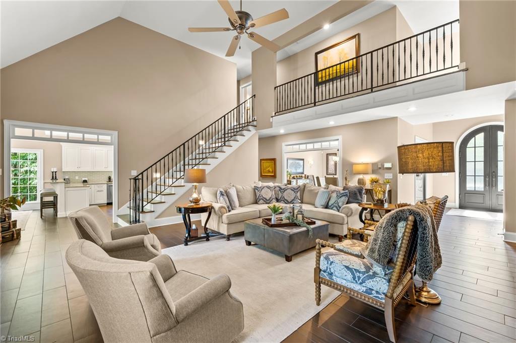 11555 Double Spring Road Lewisville, NC 27023 - Photo 11 of 50 Soaring vaulted ceilings and oversized windows with a custom iron railing to the open 2nd floor balcony