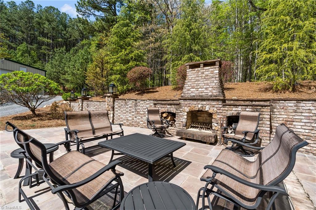 11555 Double Spring Road Lewisville, NC 27023 - Photo 46 of 50 The outdoor brick fireplace and spacious bluestone patio are perfect for quiet evenings or large gatherings!