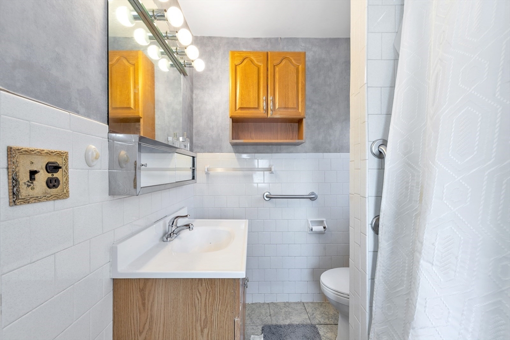 151-153 Forest Street Arlington, MA 02474 - Photo 16 of 20 a bathroom with a sink and a mirror
