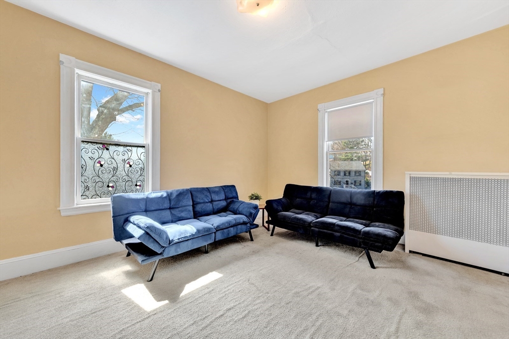 151-153 Forest Street Arlington, MA 02474 - Photo 3 of 20 a living room with furniture and a window