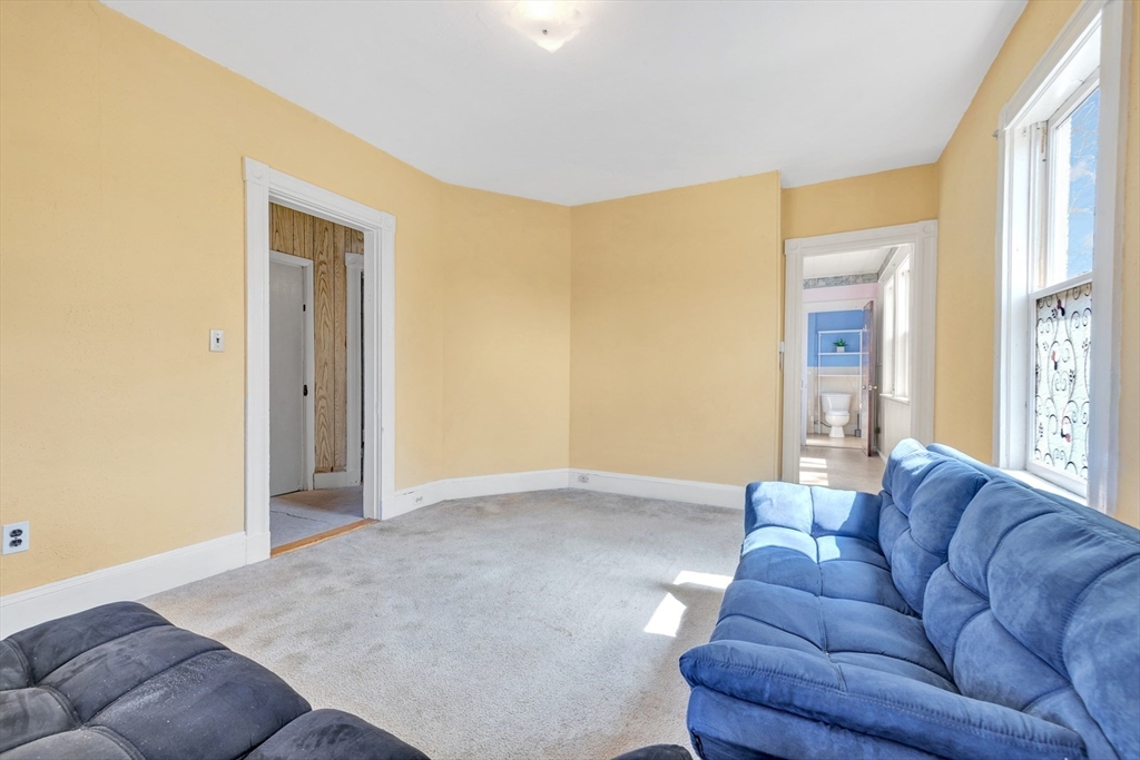 151-153 Forest Street Arlington, MA 02474 - Photo 4 of 20 a living room with furniture and a window