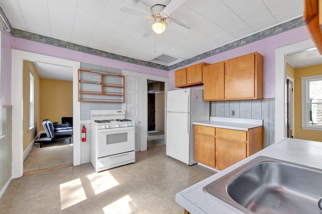 151-153 Forest Street Arlington, MA 02474 - Photo 6 of 20 a kitchen with stainless steel appliances granite countertop a sink a stove cabinets counter top space and a window