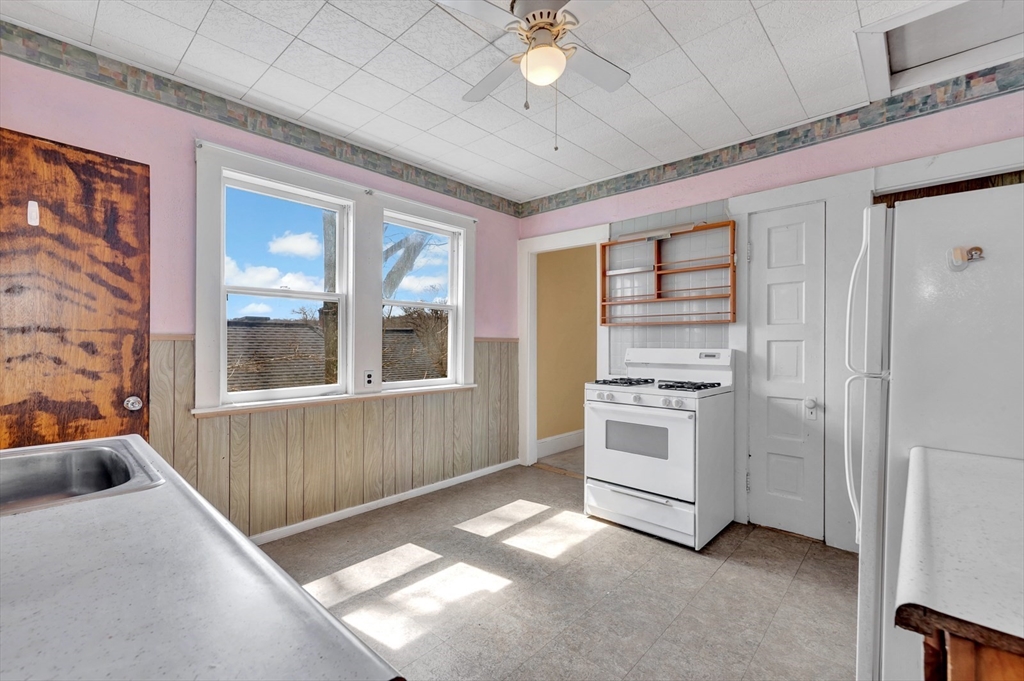 151-153 Forest Street Arlington, MA 02474 - Photo 7 of 20 a kitchen with stainless steel appliances granite countertop a stove and a refrigerator