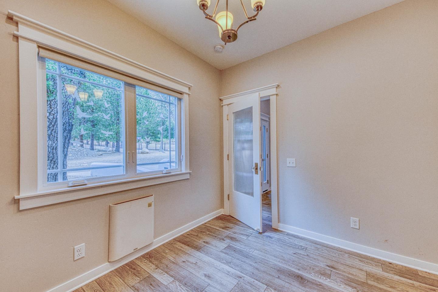47317 Arroyo Seco Road Greenfield, CA 93927 - Photo 23 of 47 an empty room with wooden floor and windows