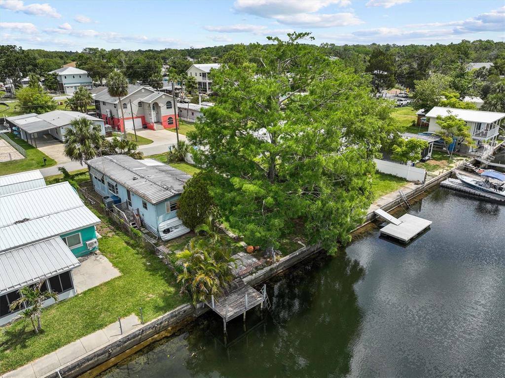 an aerial view of residential houses with outdoor space and swimming pool