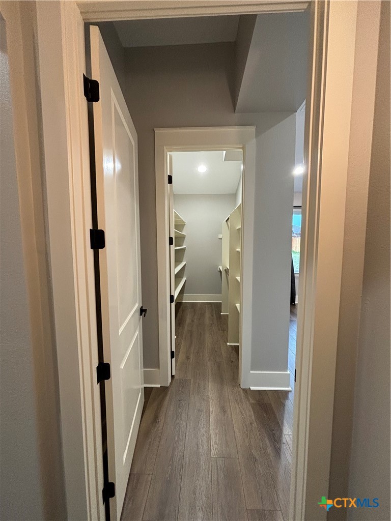 110 Hiram Cook Blanco, TX 78606 - Photo 41 of 46 a view of a hallway with wooden floor and a bathroom