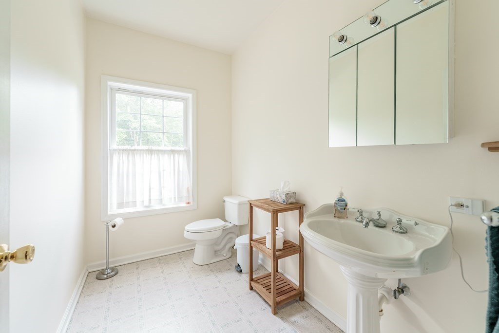 870 George Carter Road Becket, MA 01223 - Photo 15 of 37 a bathroom with a sink a toilet and a mirror