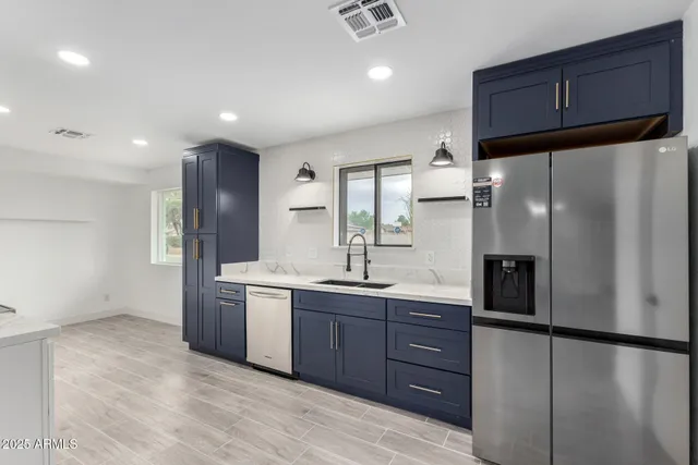 a kitchen with stainless steel appliances a refrigerator and cabinets