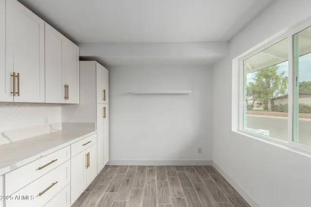 a view of a kitchen with wooden floor and electronic appliances