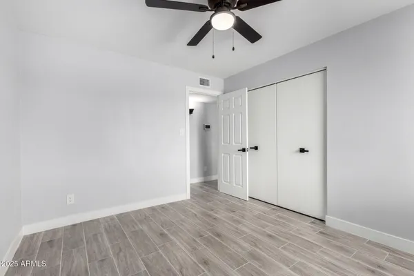 a view of empty room with wooden floor