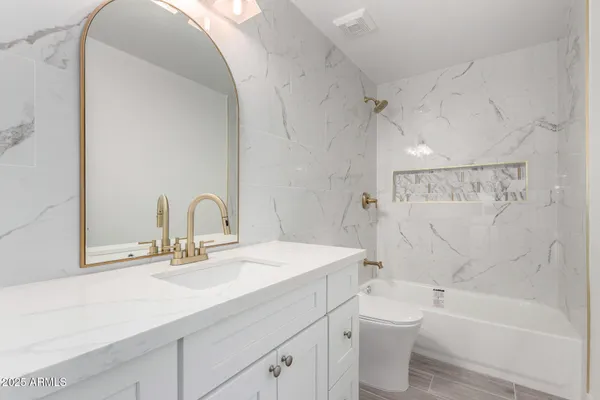 a bathroom with a sink a toilet and a bathtub