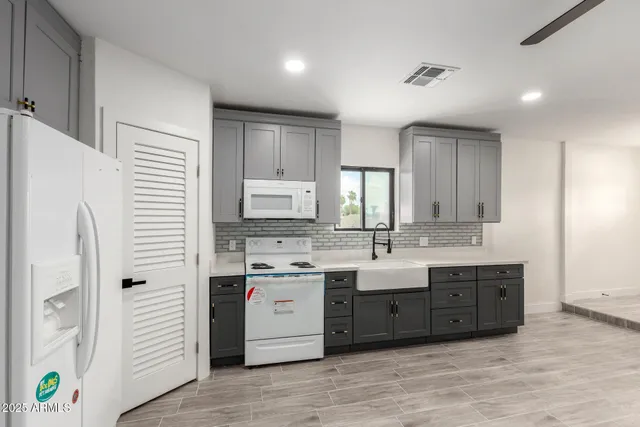 a bathroom with a double vanity sink and a mirror
