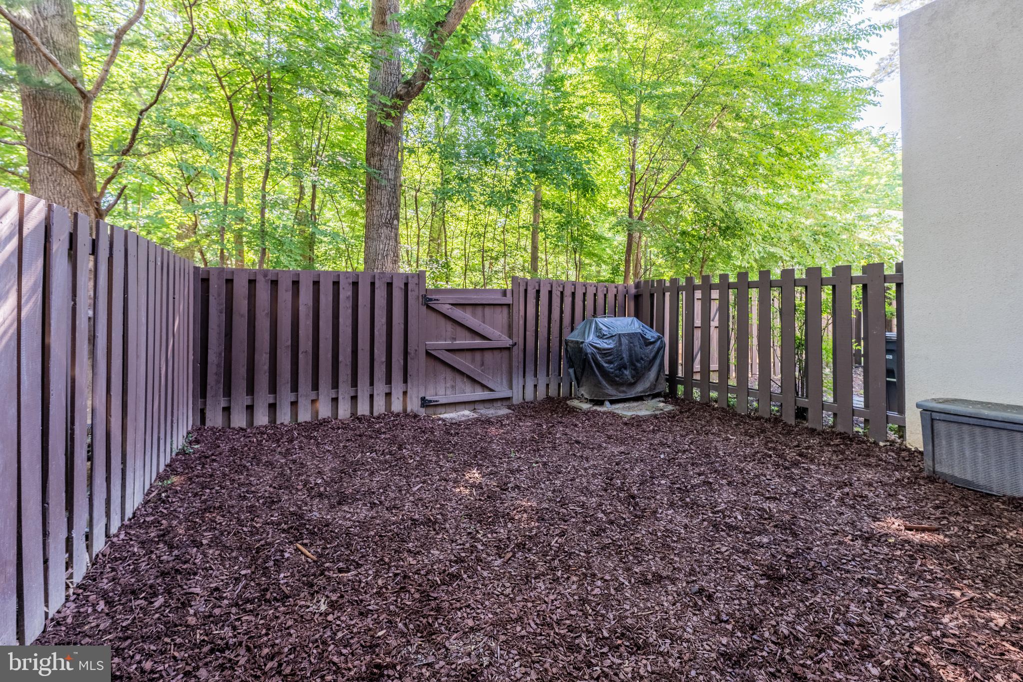 11917 Barrel Cooper Court Reston, VA 20191 - Photo 41 of 59 a view of a backyard with plants and wooden fence