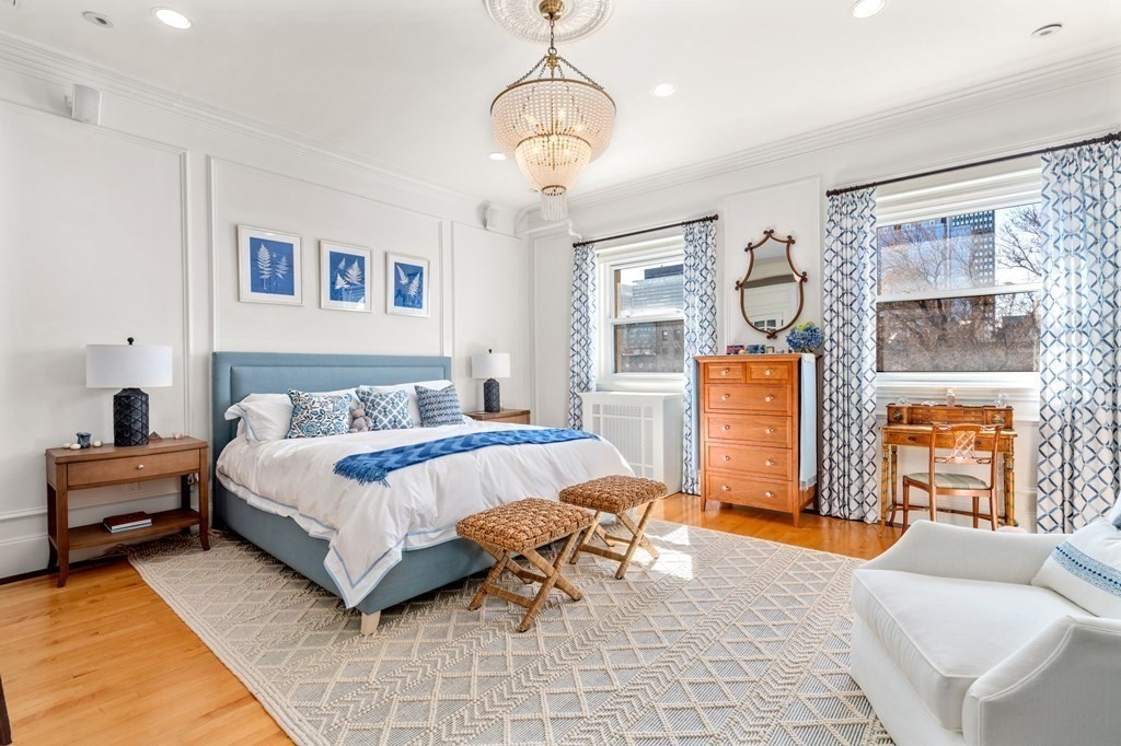 273 Commonwealth Avenue, Unit 9 Boston, MA 02116 - Photo 3 of 26 a spacious bedroom with a bed a bookshelf window and couch