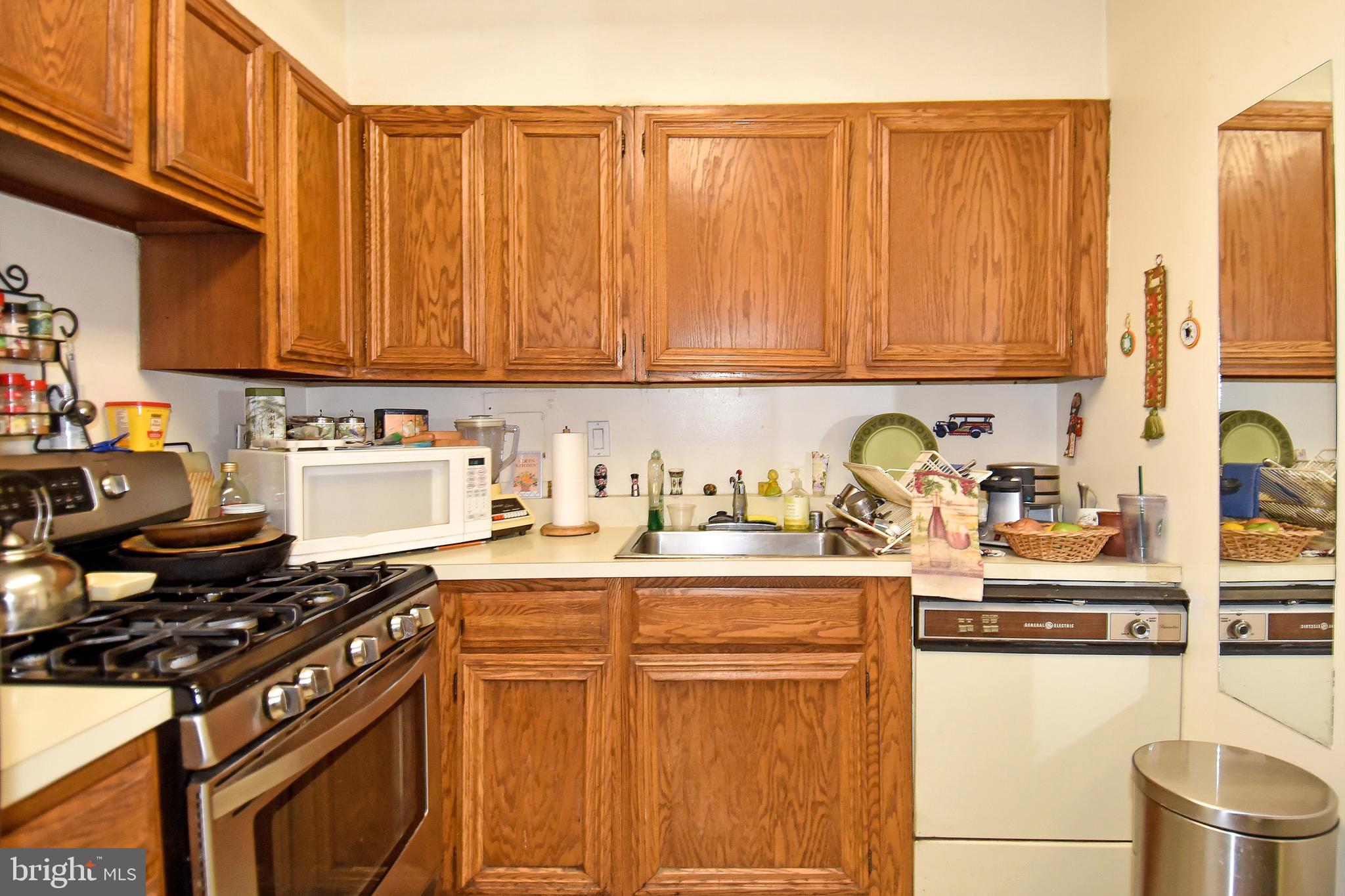429 N Street Southwest, Unit S607 Washington, DC 20024 - Photo 13 of 55 a kitchen with stainless steel appliances granite countertop a stove top oven a sink dishwasher and cabinets with wooden floor