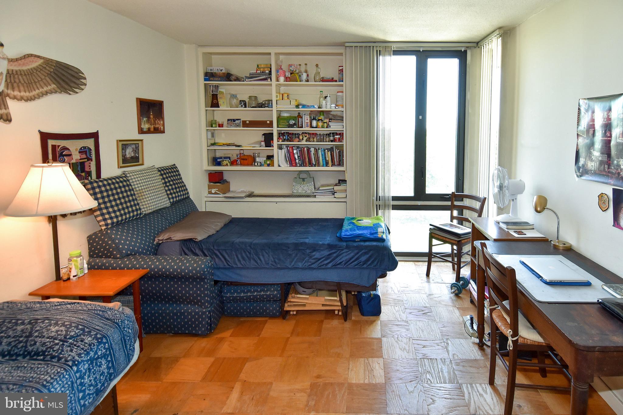 429 N Street Southwest, Unit S607 Washington, DC 20024 - Photo 18 of 55 a living room with furniture and a book shelf