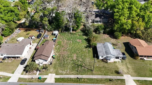 an aerial view of a house with a yard basket ball court and outdoor seating